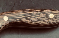 Black Palm is a unique and visually striking knife handle material. It has distinct black fibers interspersed with lighter shades, black palm creates a beautiful contrast and adds an exotic touch to any knifemaking project. Shown is a knife handle with yellow and black streaks.