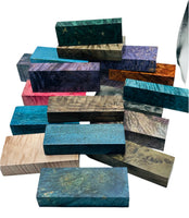 Arranged pile of multi-coloured stabilized wood blocks for custom knife handles.