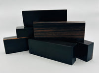 Stabilized Ceylon Ebony, also known as Indian Ebony is an exotic wood most ordinarily native to southern India and Sri Lanka. It makes beautiful knife handles. Shown are  a pile of blocks.