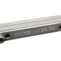 Two pieces of metal with a large screw on either end. A file guide are used mainly for grinding the ricasso and hidden tang shoulders for custom knife making.
