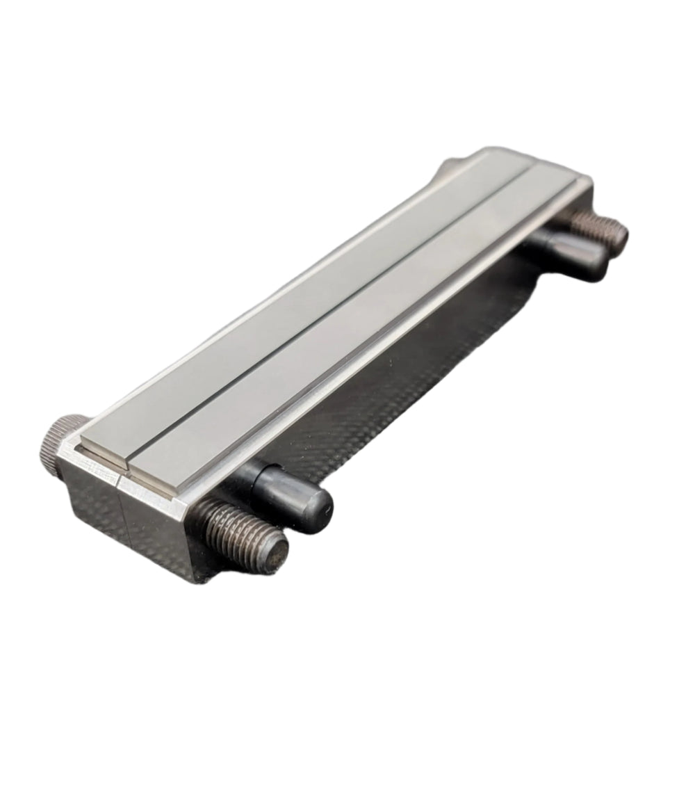 Two pieces of metal with a large screw on either end. A file guide are used mainly for grinding the ricasso and hidden tang shoulders for custom knife making.