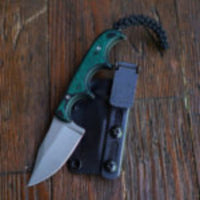 
              Ulticlip Slim 2.2 on a knife sheath beside a knife. 
            
