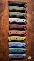 
              Grip-Tec™ is a revolutionary rubber and resin composite  ideal for hunting knives, filet knives, kitchen knives, and your favorite EDC knife. It comes in many vibrant colours. Shown are a variety of colours on knife handles. 
            