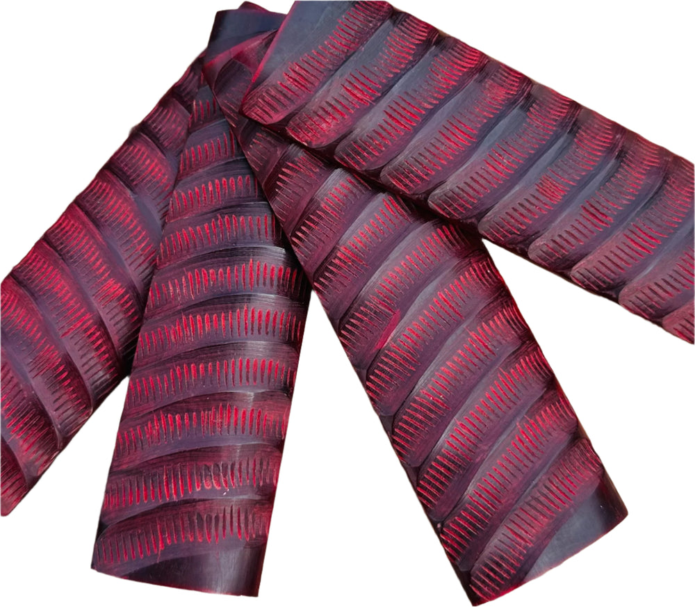 Buffalo Horn - Red Impala Jigged is a unique pattern. The jigging adds texture and grip, ensuring a secure hold during use of any knife. Shows four scales in a fan. 