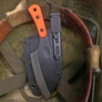 Ulticlip Slim 2.2 on a knife sheath beside a cleaver. 