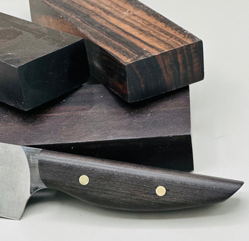 Stabilized Ceylon Ebony, also known as Indian Ebony is an exotic wood most ordinarily native to southern India and Sri Lanka. It makes beautiful knife handles. Shown are three blocks and a knife handle. 