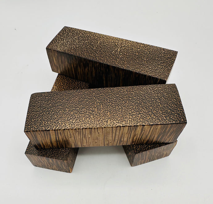 Sourced from the black palm tree, this knife making handle material features a distinctive pattern with a rich, dark base interspersed with lighter streaks and flecks, creating an eye-catching, speckled appearance.