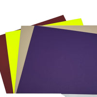 Four sheets of colored Kydex in purple, yellow, beige, and brown on a white background
