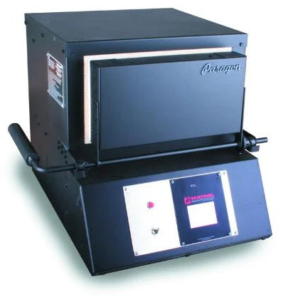 Front door closed of a black rectangular kiln (heat treat oven) with digital controls on for heat treating custom knives.