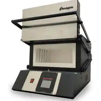 Front door open of a black rectangular kiln (heat treat oven) with digital controls on for heat treating custom knives.