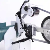 Close up view of wheels of 2" x 72" belt grinder for knife making of custom knives.