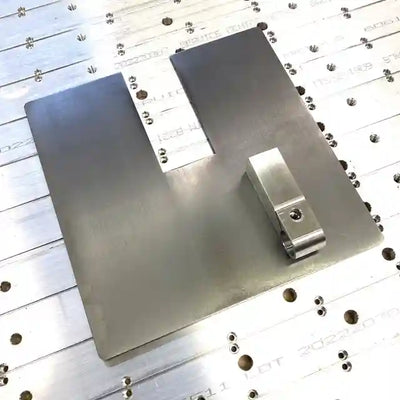 Image of a steel plate with a center notch for the knife making grinder.